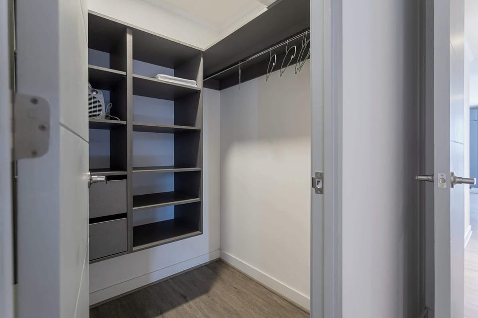 Spacious walk-in closet with ample shelving and hanging space for a clutter-free stay.