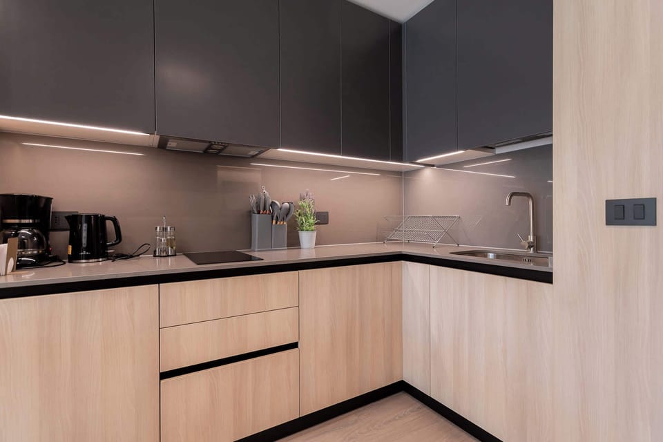 Experience culinary bliss in this sleek, modern kitchen featuring stylish cabinetry and top-notch appliances, perfect for your vacation cooking adventures!