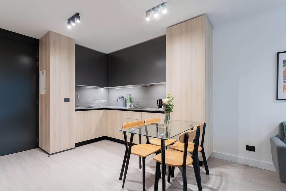 Savor meals in this chic kitchen with modern cabinetry and a stylish dining area, perfect for intimate gatherings.