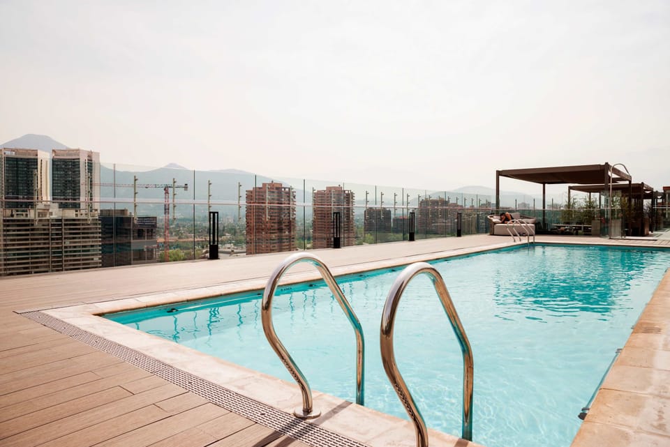 Relax at the rooftop pool with breathtaking city and mountain views, perfect for unwinding in style.