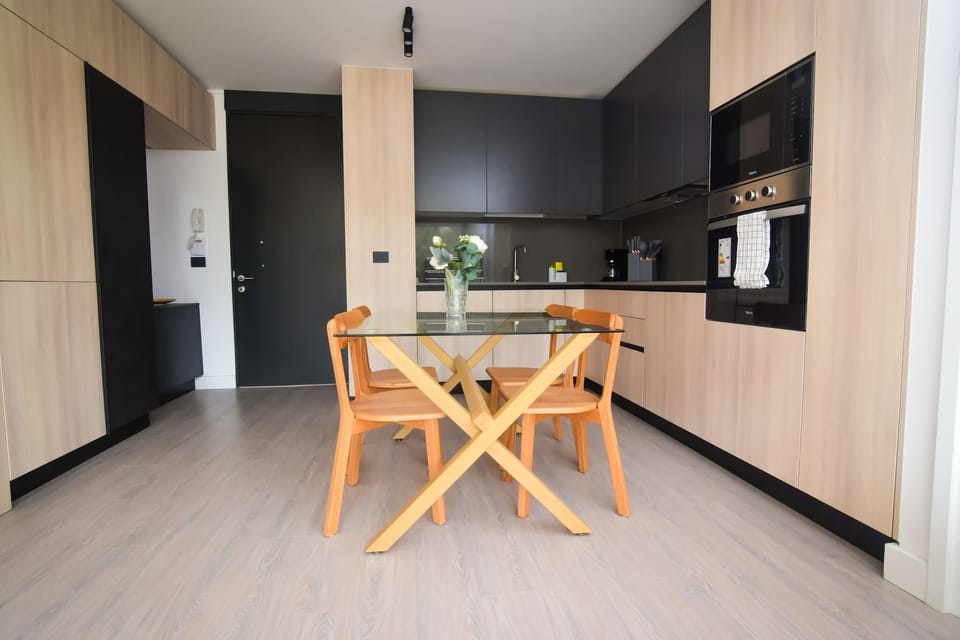 Sleek and modern kitchen with a stylish dining area, perfect for enjoying meals in comfort.