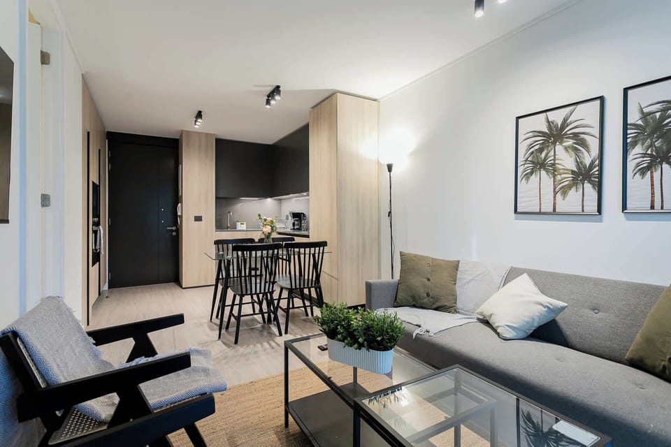 Modern studio with chic decor and a cozy dining area, perfect for relaxation and entertaining.
