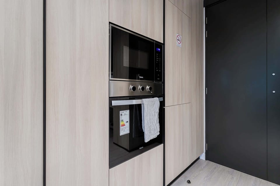 Sleek kitchen with modern appliances and stylish cabinetry, ideal for culinary enthusiasts.
