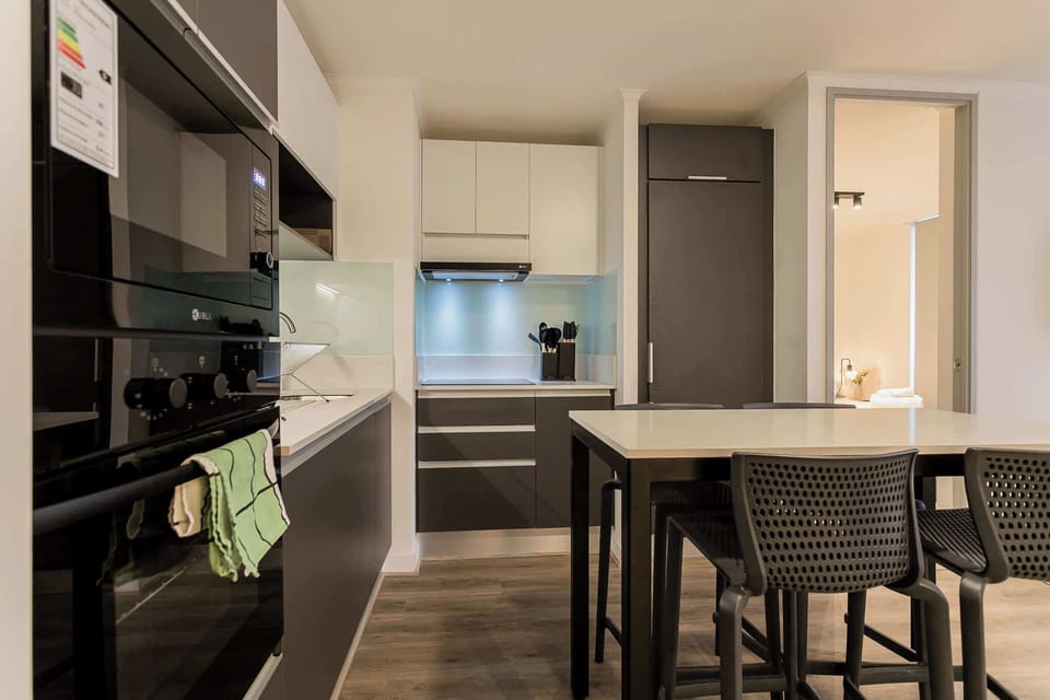 Sleek and modern kitchen with dining area, perfect for enjoying home-cooked meals in style.
