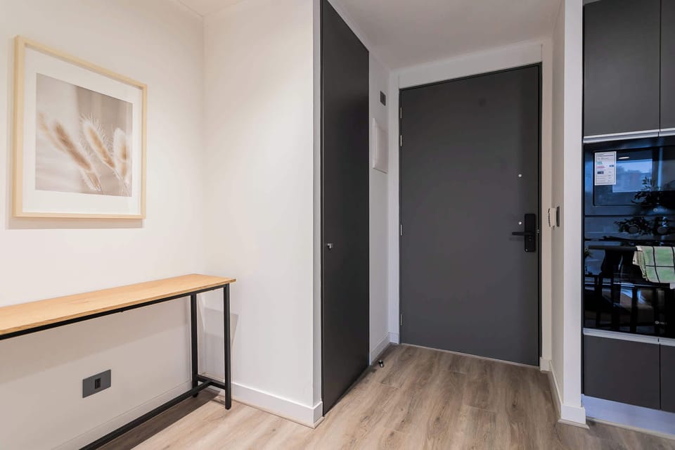 Step into a sleek and modern entrance, setting the tone for your stay in this stylish apartment.