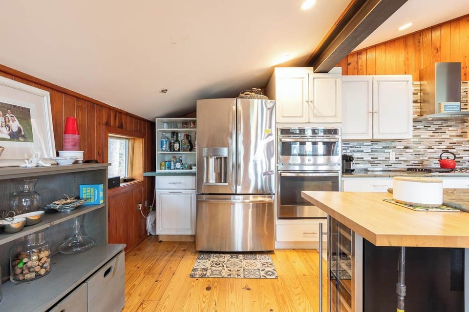 Fully Equipped Kitchen with Refrigerator, Stove, Oven, Microwave,Dishwasher,Nespresso Tea Kettle, Generous Counter Space, Center Island, and Bar Seating, Perfect for Cooking and Socializing Together