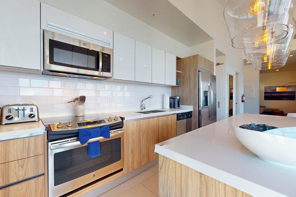 Your modern kitchen features sleek cabinetry, stainless appliances, and a bright island workspace—perfect for preparing meals and gathering with loved ones.