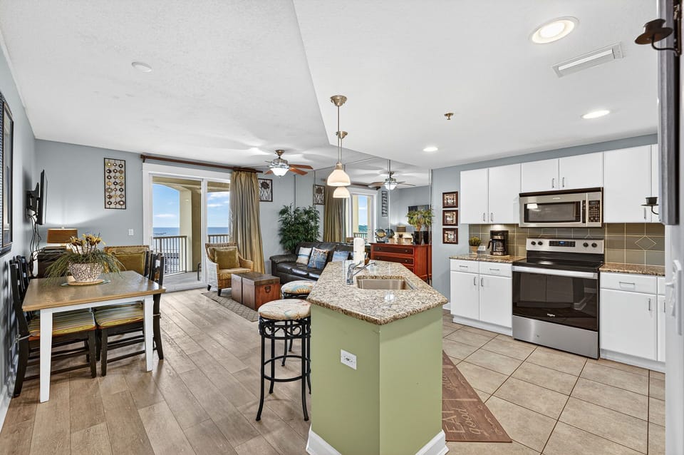 Open-concept kitchen and living area with ocean views and modern finishes.