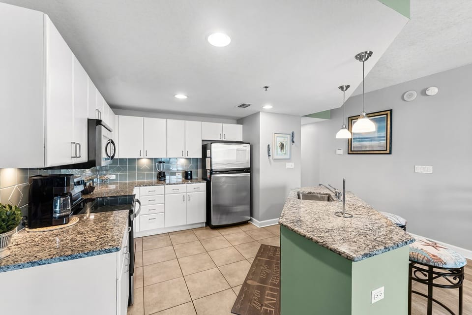 modern kitchen with granite countertops and stainless steel appliances