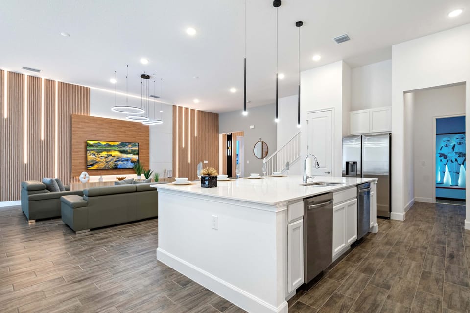 Stylish open kitchen with island seating, modern lighting, and seamless flow
