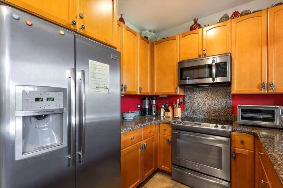 Fully equipped kitchen with modern appliances and granite countertops, perfect for preparing family meals.