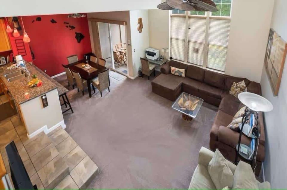 Spacious living room flowing into a vibrant kitchen, ideal for social gatherings and family dinners.