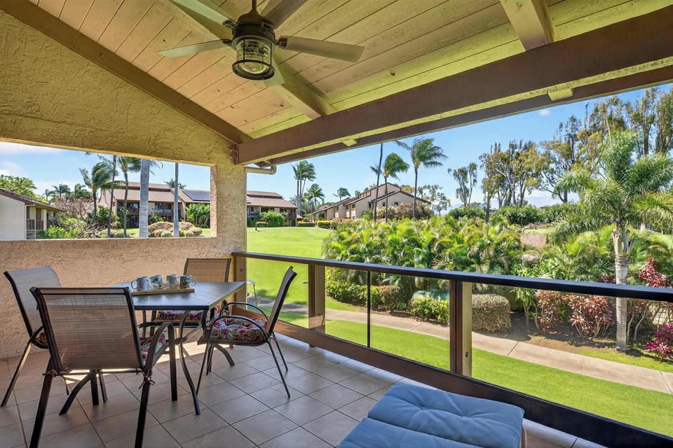 Covered lanai features a built in wet bar, comfy lounger, and island decor for laid back vibes.