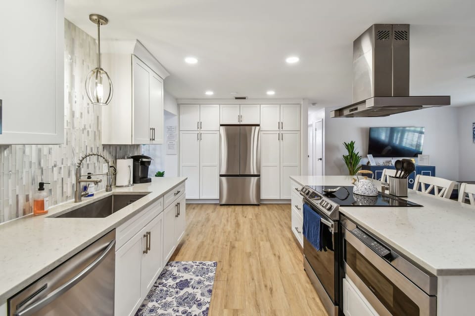 Cook & chat in fully equipped kitchen with stainless appliances and bar seating