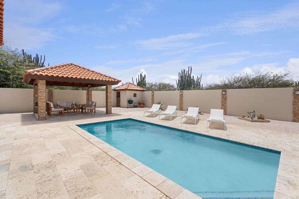Private pool with loungers & shaded gazebo Relax by your private pool with comfortable sun loungers and a shaded gazebo featuring a lounge area. Whether you’re sunbathing or cooling off in the shade, this villa offers the best outdoor living experience in