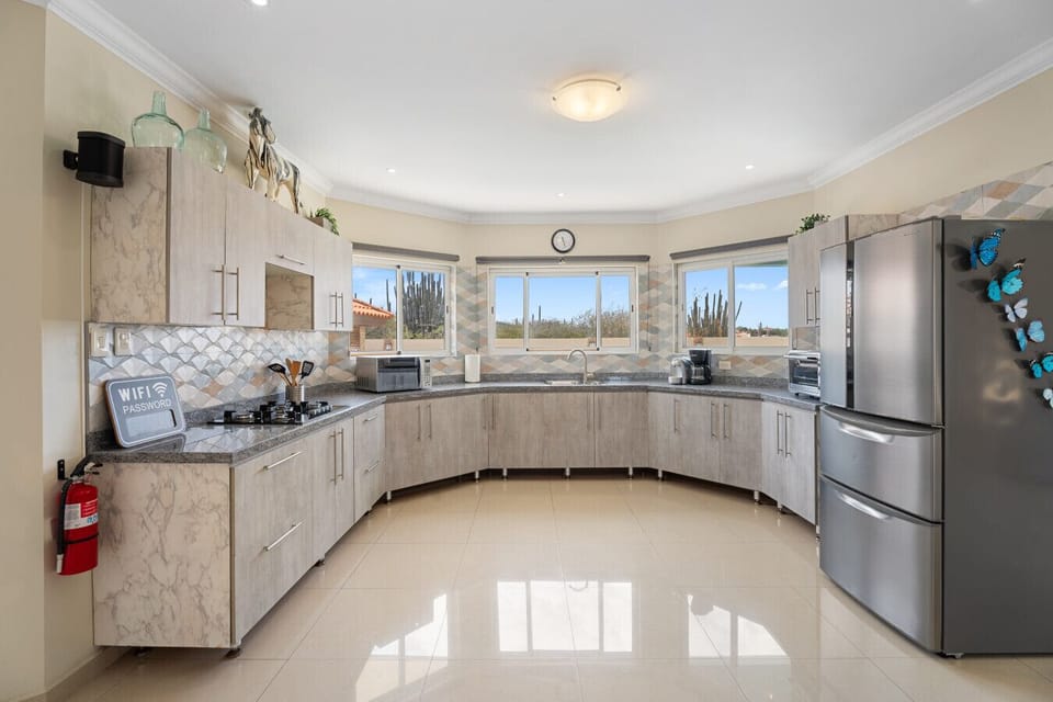Bright kitchen The villa’s kitchen combines functionality with style, offering all essentials for cooking. A true centerpiece for your group’s culinary moments.