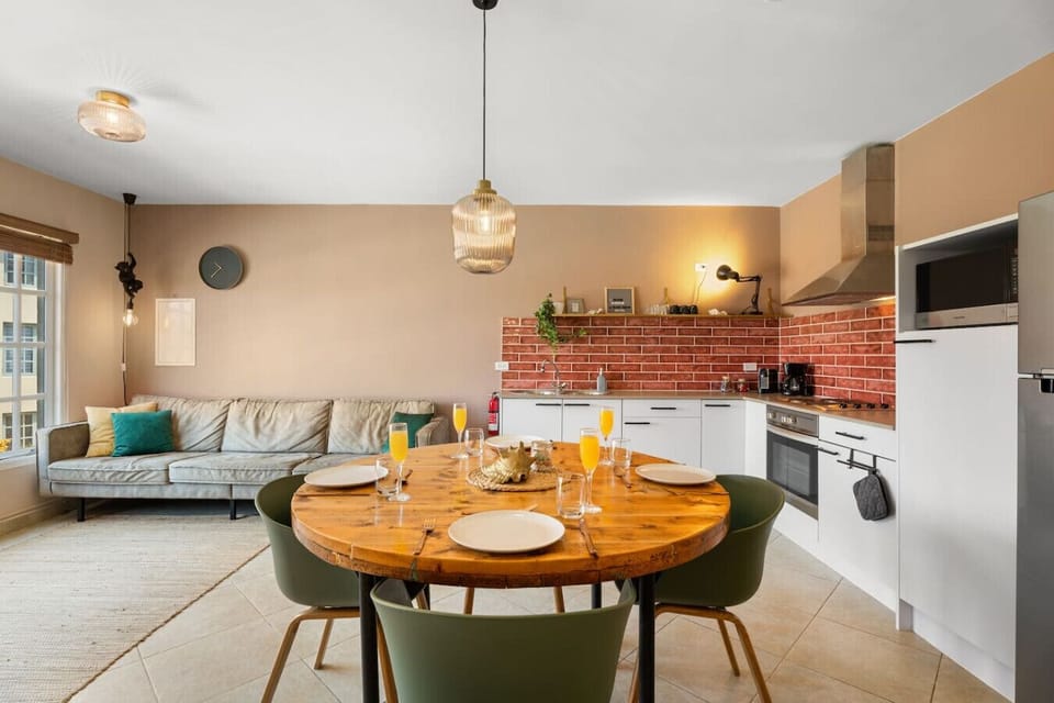 Open layout living room connected to kitchen with dining area