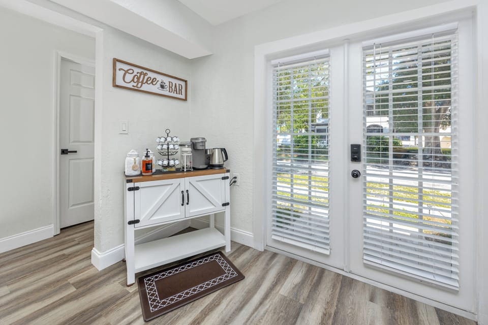 Coffee bar featuring Kuerig, french press, 12 cup coffee maker with a kettle  