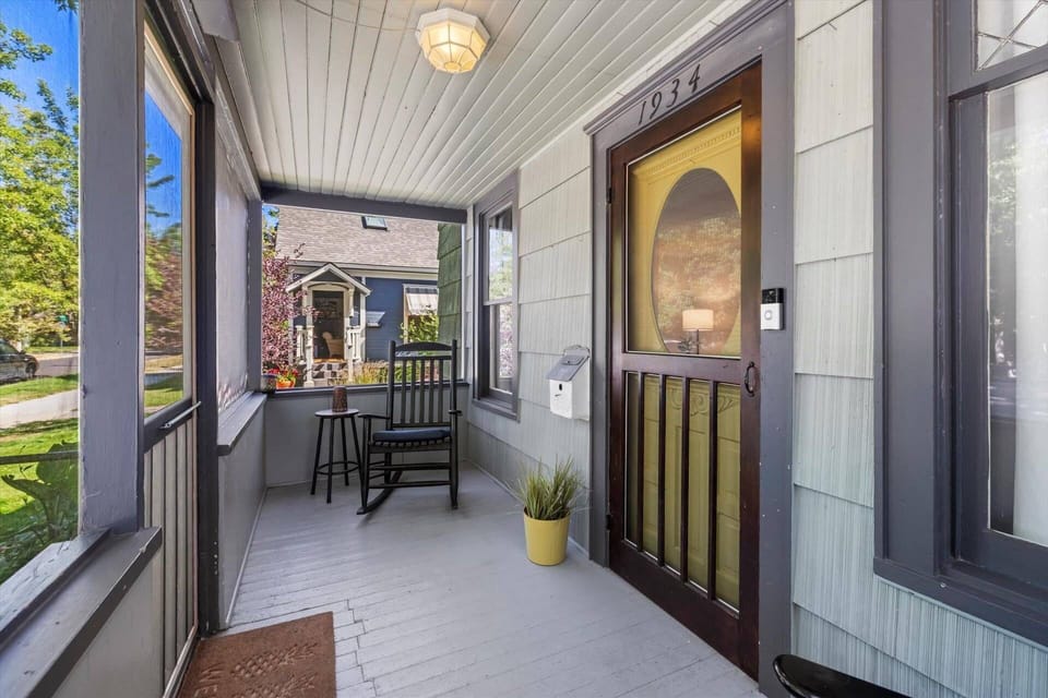Screened-in front porch with rocking chairs - ideal for slow mornings or evening chats