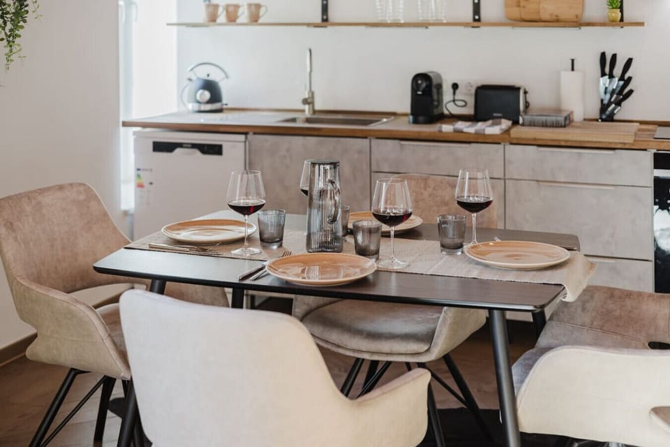 Table elegantly set with wine glasses and modern decor — perfect for special moments.