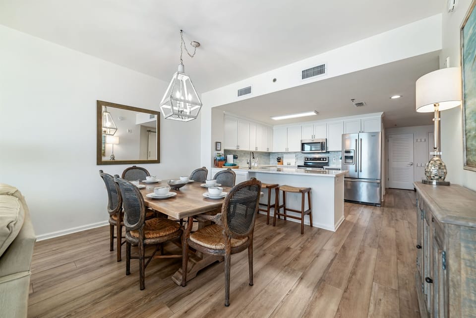 Gather around the elegant dining table, ready for memorable meals and conversations in this beautifully appointed bayfront condo.