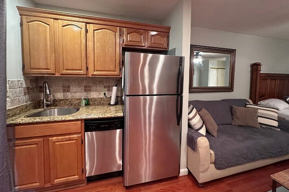 Full-size stainless-steel appliances in this kitchenette including oven/stove, fridge/freezer, dishwasher, and microwave!