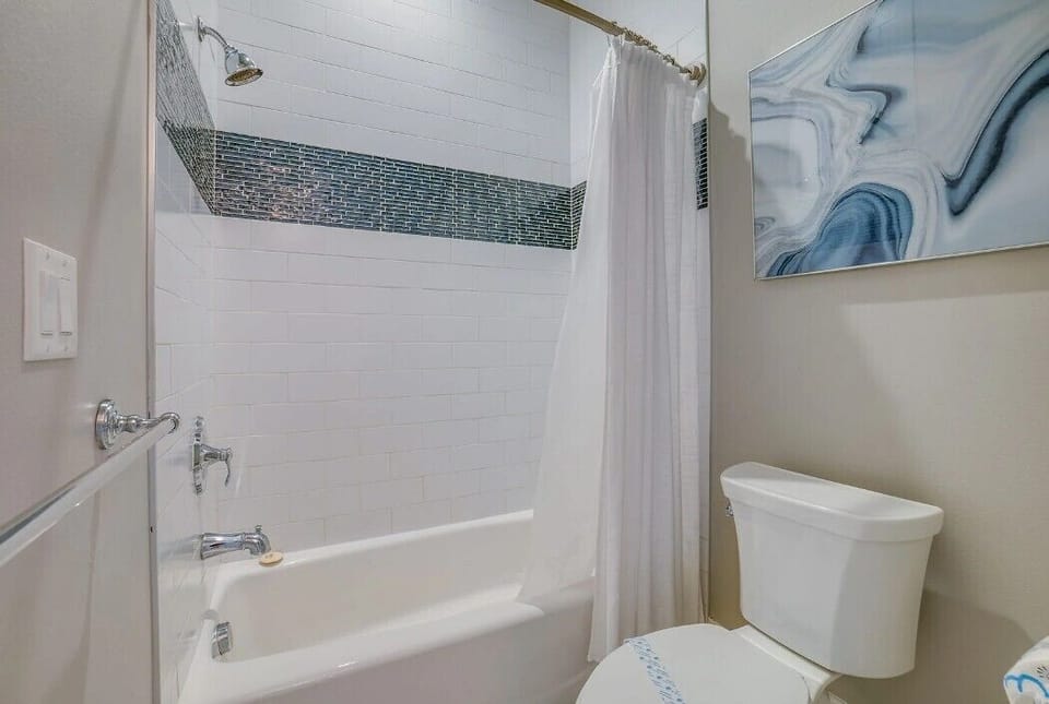 Bathroom- Bunk bedroom with bathtub and shower combination 