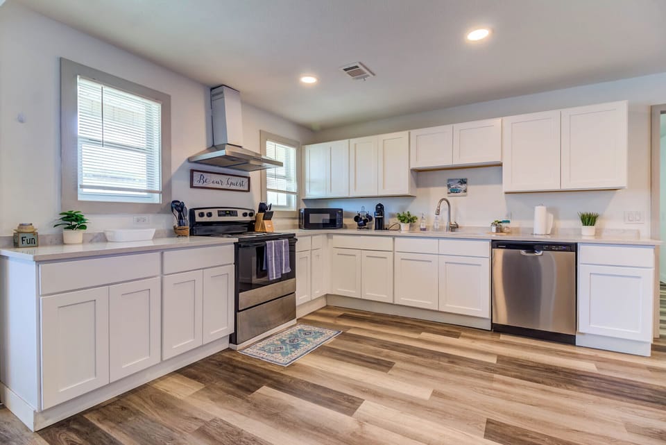 Open and inviting kitchen w/ stainless steel appliances 