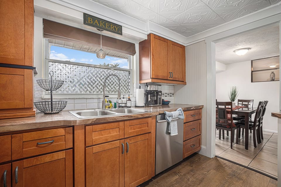 Fully stocked kitchen with dishes, utensils and appliances