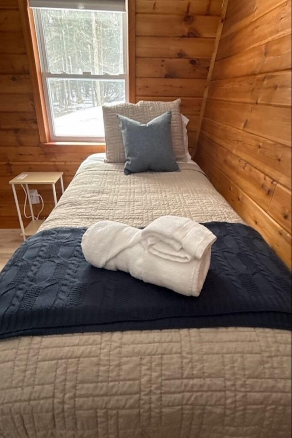 Additional bedroom with warm, inviting design and natural light
