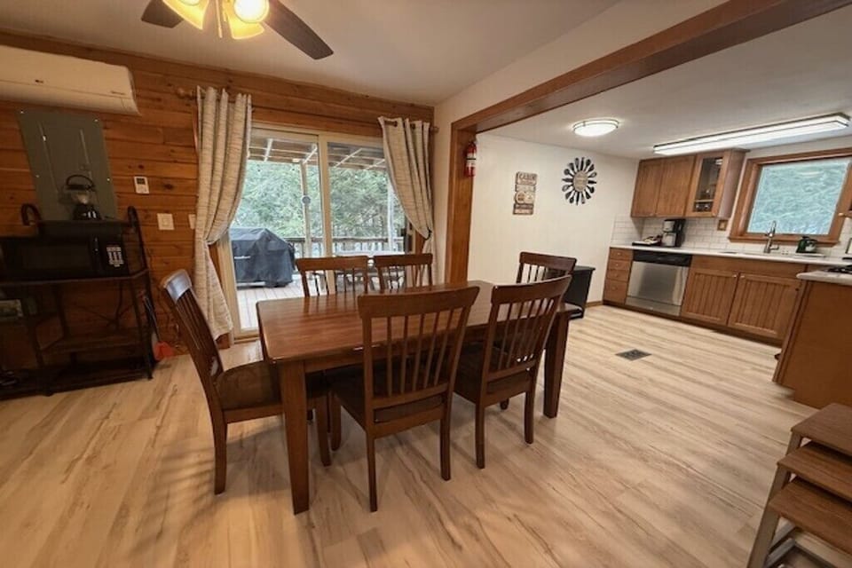 Dining area with access to outdoor deck and scenic views