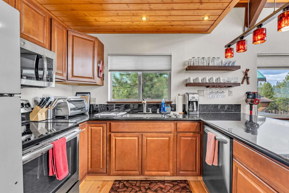 Kitchen: Main floor, drip coffee maker, toaster oven, Crockpot, waffle maker, cooking utensils, tableware