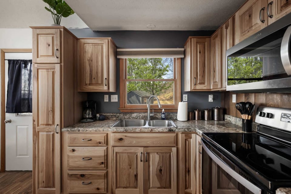 kitchen with natural wood cabinets and a window view of the outdoors