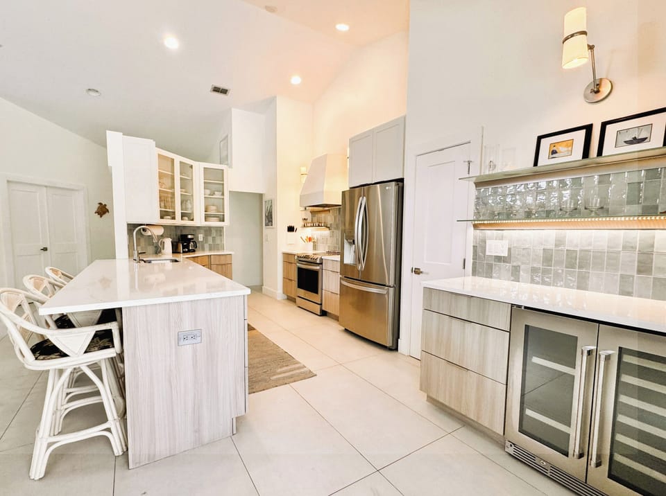 Fully equipped with a modern oven and stovetop, a microwave, and a dishwasher.