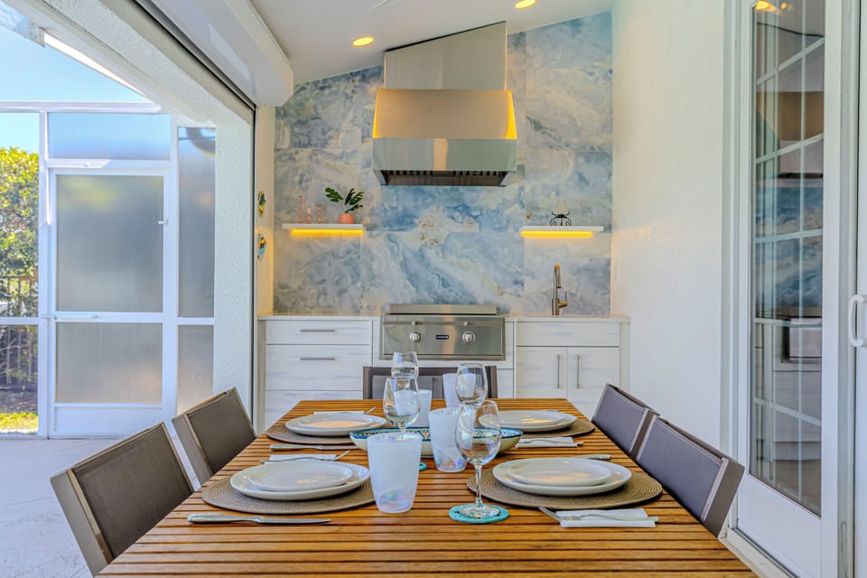 Designed for outdoor living with an outdoor kitchen with a sink and gas grill.