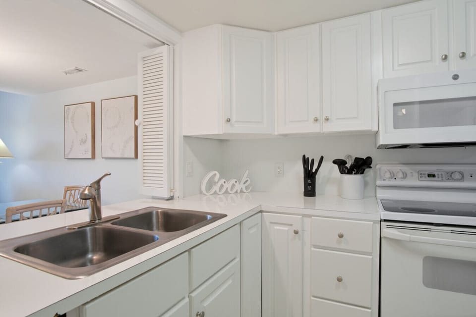 Full Kitchen overlooks open living room and dining room