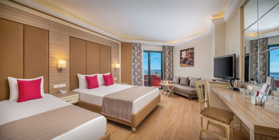 Standard Room, Partial Sea View | Minibar, in-room safe, soundproofing, free cribs/infant beds