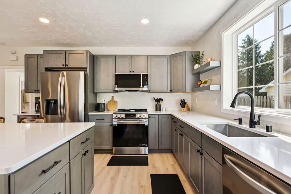 Modern stainless steel appliances make it easy to cook with a glass of wine!