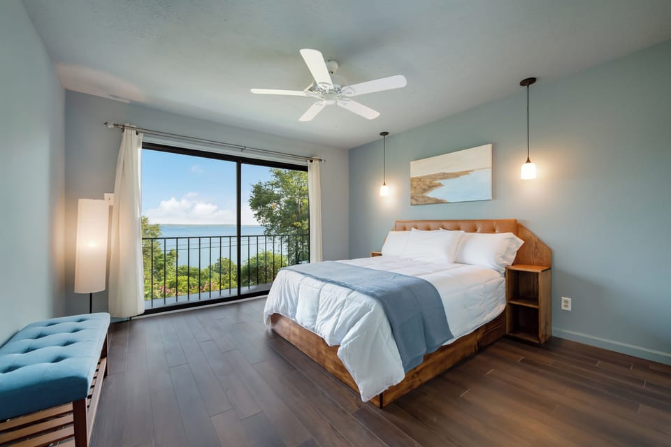This bedroom also has a lake view, closets and TV