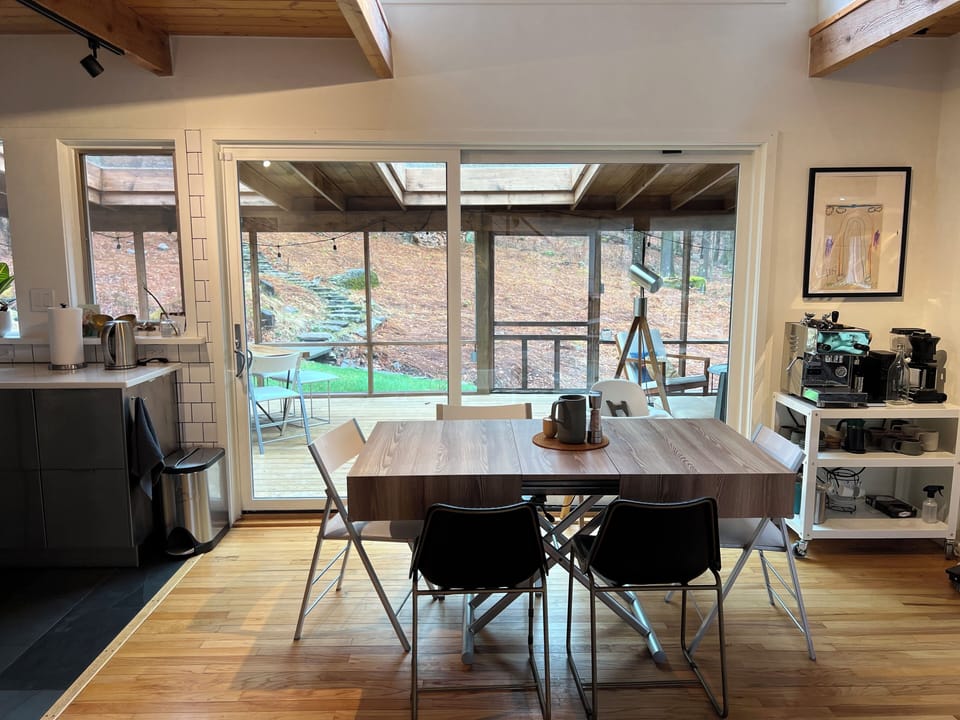 Large sliding door open to enormous enclosed porch with additional seating 