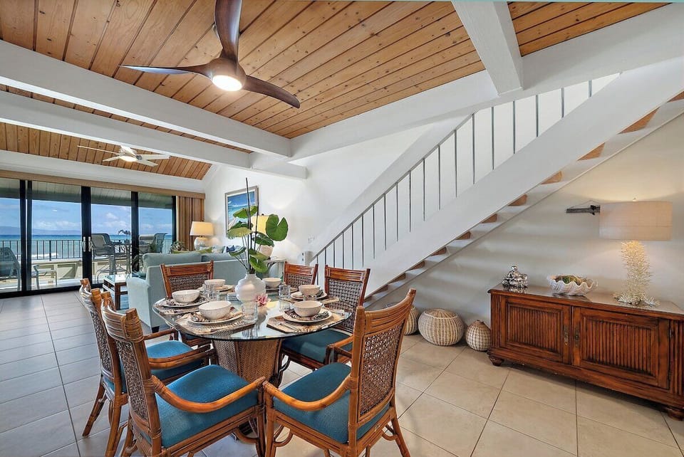 Ocean view Dining area with rattan chairs and stair case