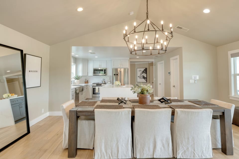 Formal dining table set under a stunning chandelier.