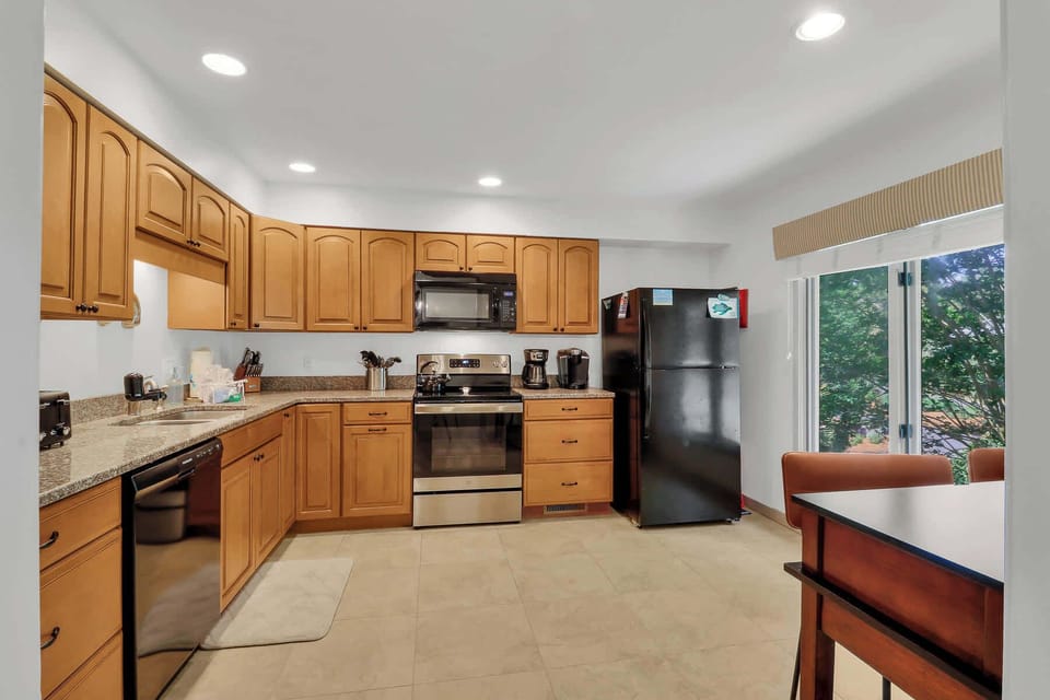 Fully stocked kitchen with cookware and dishware