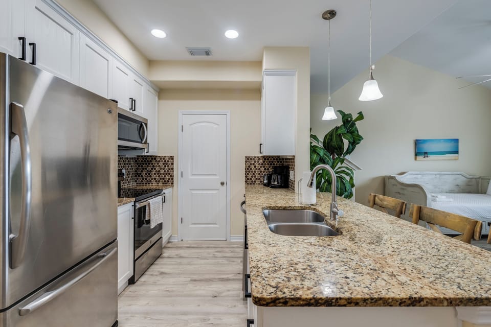 Your modern kitchen features granite counters, stainless appliances, and a stylish backsplash—ready for cooking and gathering over meals together.