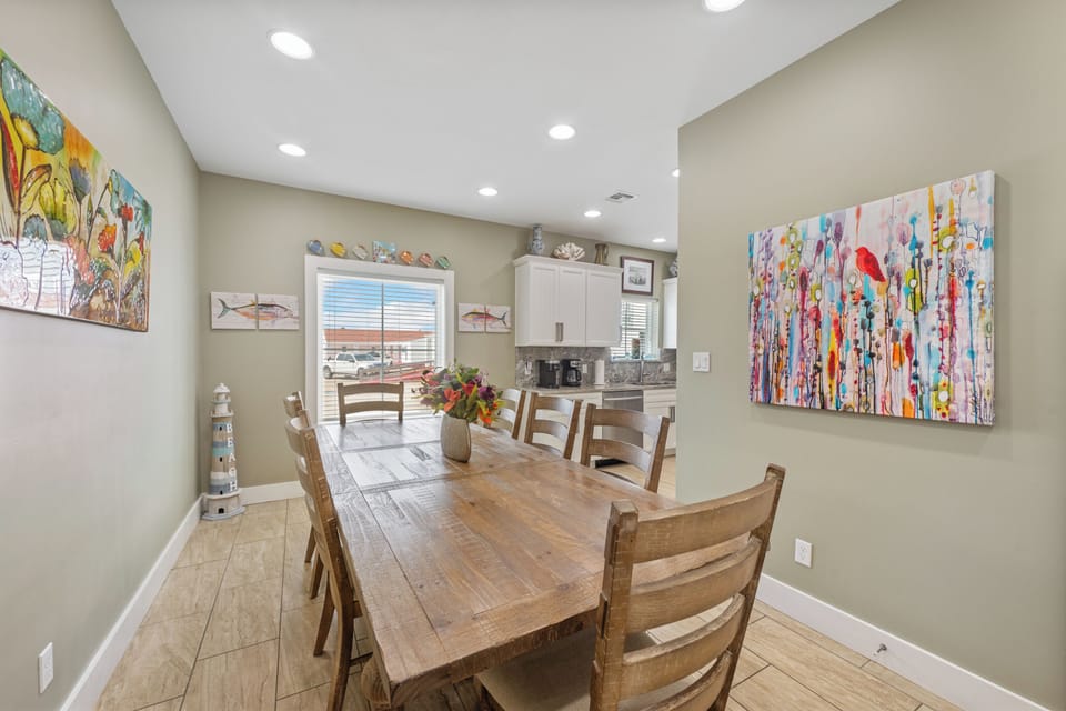 Gather around your spacious dining table for memorable meals, surrounded by vibrant local artwork and an open kitchen perfect for vacation cooking.