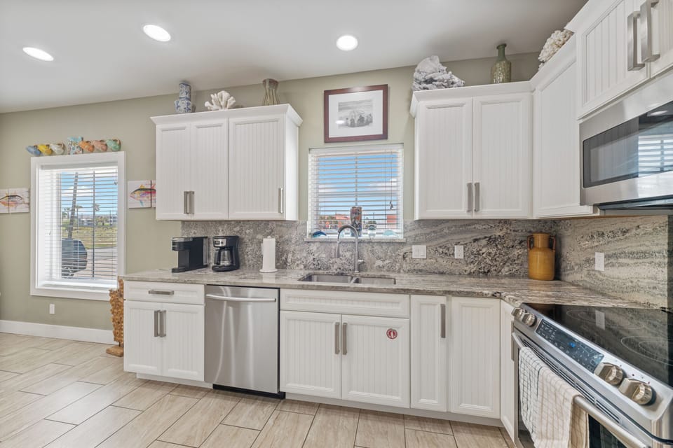 Your spacious kitchen awaits with granite counters, stainless appliances, and everything you need to create memorable vacation meals together.