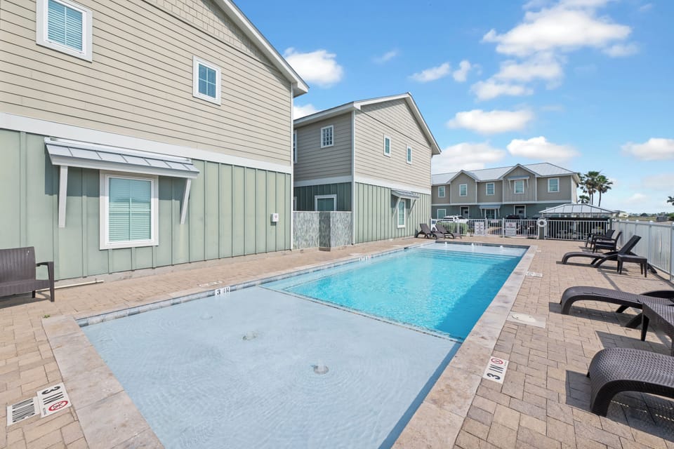 Sparkling pool surrounded by comfortable lounge chairs where you can soak up the Florida sunshine between beach adventures.