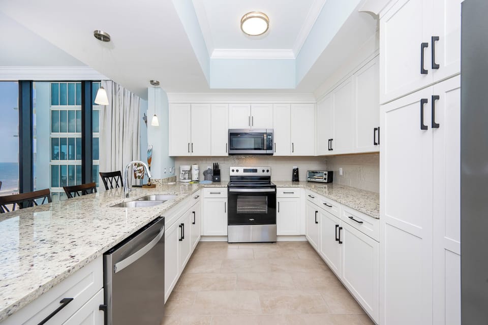 Cook and gather in this kitchen, featuring a spacious countertop and stainless appliances