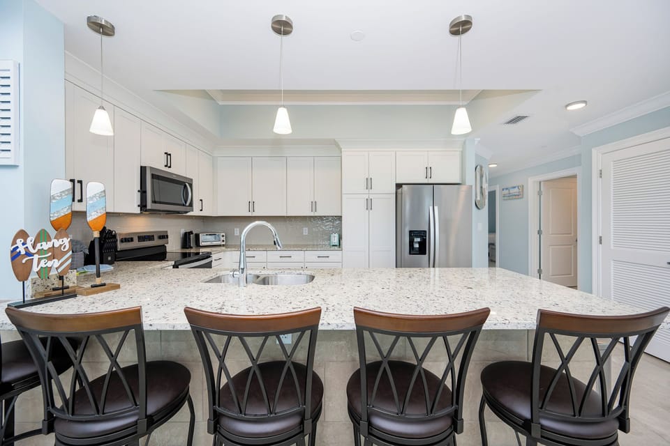 Gather around the sleek kitchen for morning coffee, perfect for enjoying time with loved ones