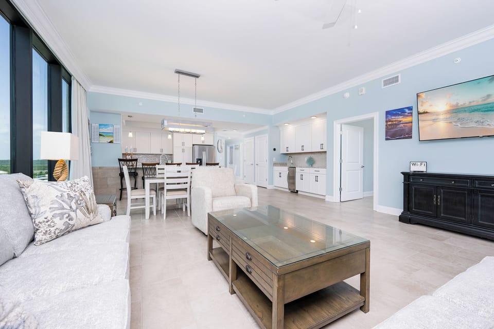 Relax in the spacious living area with comfortable seating, a large TV, and a dining space perfect for meals together
